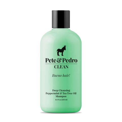Green shampoo bottle with black cap and branding on a white background