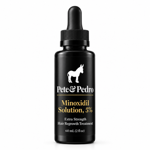 A black bottle of Pete & Pedro Minoxidil Solution, 5% Extra Strength Hair Regrowth Treatment with a black dropper cap, on a white background.
