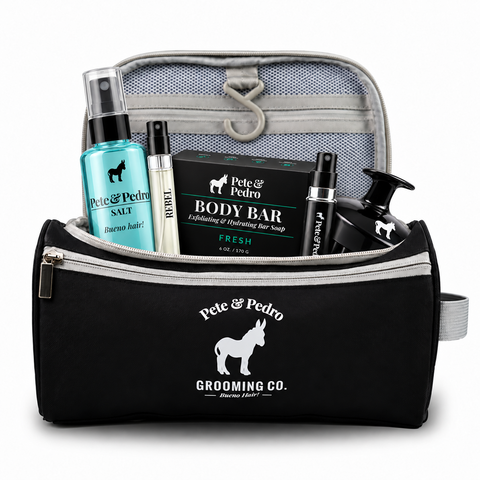 Pete & Pedro travel bag filled with Sea Salt Spray, Body Bar, Scalp Massage Brush, Rebel fragrance sample, and refillable cologne travel sprayer