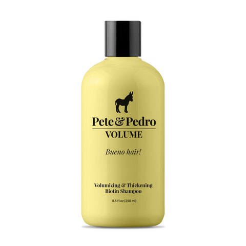 A bottle of Pete & Pedro Volume Biotin Shampoo with a pale yellow body, black cap, and black printed logo and text on a white background.